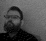 A pixelated headshot of a bearded man wearing glasses